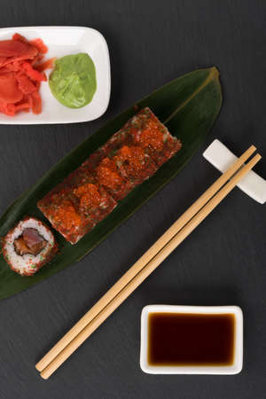 tuna rolls lie on a bamboo leaf next to the sauce, top viewの写真素材