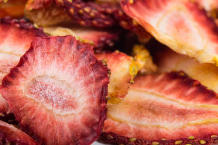 sliced pieces of dried strawberries, as a background, close-upの写真素材
