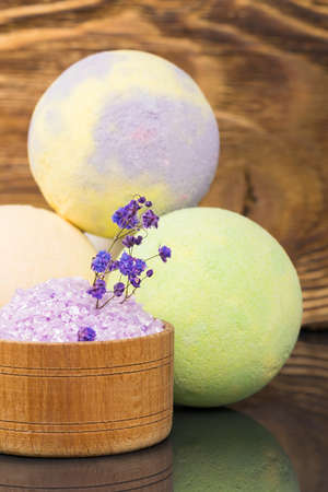 bath salt and dissolving aroma balls on a dark wooden background, close-up viewの写真素材