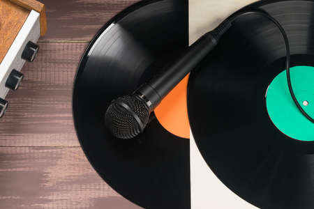 microphone lies on two vinyl records, top viewの写真素材