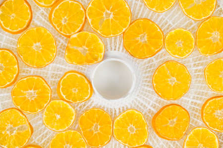 dried mandarin rings lie on drying trays, background