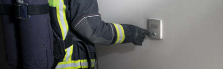 close-up of the intercom button, the fireman's hand pressesの写真素材