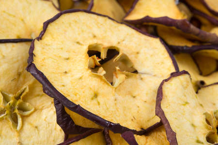 sliced pieces of dried red apples as a background, close-upの写真素材