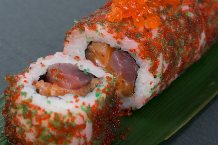 close-up of sliced rolls with caviar fish, vegetables, tuna as backgroundの写真素材