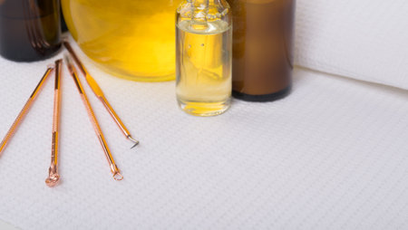 on a white sterile waffle towel, oil and cream for moisturizing and sticks for cleaning the face from pores and pimples, there is a place for the inscriptionの写真素材
