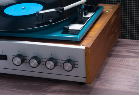 on a wooden table, an old music player, close-up