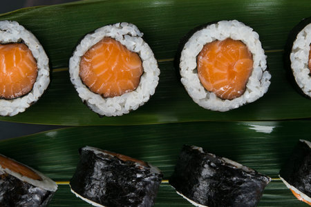on a bamboo leaf, close-up, japanese salmon rollsの写真素材