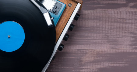 there are records and a vinyl record player on a wooden table, there are places for inscriptionsの写真素材