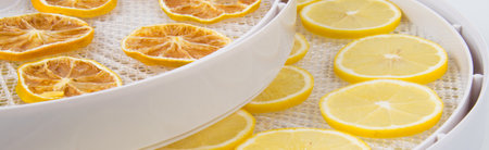 Slices of lemon in a white bowl on a white backgroundの写真素材