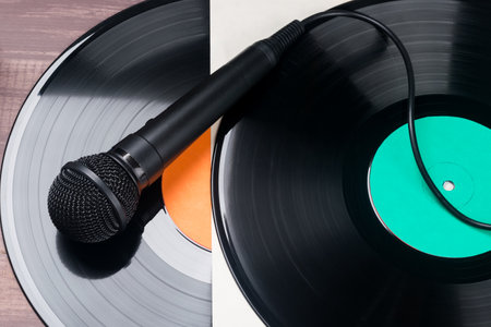 Vinyl record and microphone on a wooden background. close-up.の写真素材