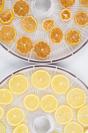close-up, on two white grates, sliced round fresh and dried lemonの写真素材