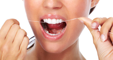 Woman teeth with dental floss. Dentistry health care.の写真素材