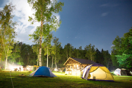 Camping tent under stars at nightの写真素材
