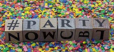 Party written on wooden blocks isolated on confetti backgroundの写真素材