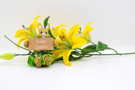 "Happy Easter" bunny and a yellow flower isolated on white backgroundの写真素材
