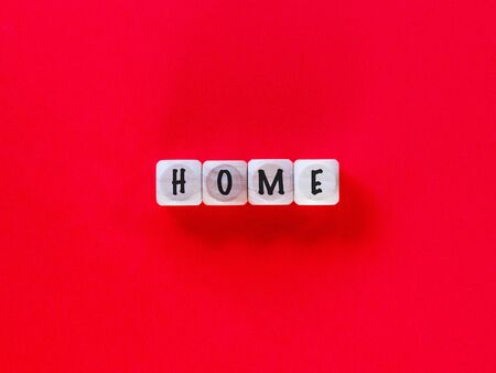 Home written on wooden blocks isolated on red backgroundの写真素材