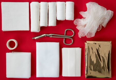 Insides of a first aid kit isolated on a red backgroundの写真素材