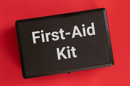 First-aid kit isolated on a red backgroundの写真素材