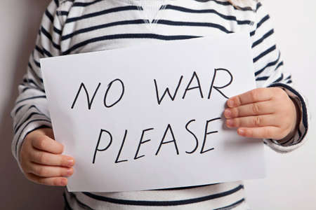 No war please text written on paper held by a childの写真素材