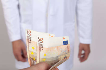 Close-up doctor takes moneyの写真素材