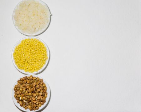 Set of colors food rice millet buckwheats on the plate on the white backgroundの写真素材
