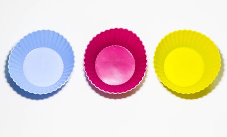 Set of colors silicon moulds for baking muffins on the white backgroundの写真素材