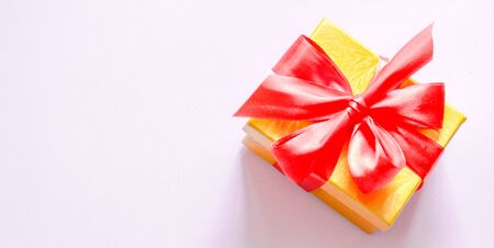 Banner gift box with red bow on a pink background. Flat lay. Top view.の写真素材