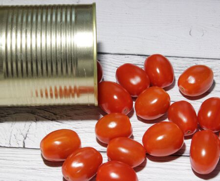 Fresh red cherry tomatoes spilled from a canの写真素材