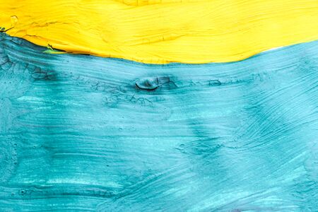 Abstract color background drawn with yellow and blue paintsの写真素材