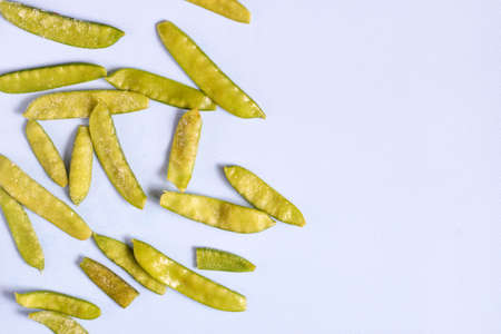 Frozen vegetables such as pea pods on a blue background. Copy space. Top view. Horizontal orientationの写真素材