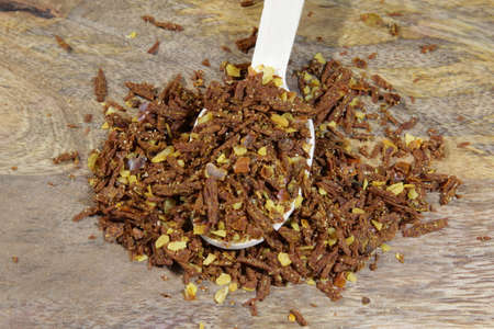 Spicy Chili paste mix with peppers on wooden background. This condiment could be ingredient of...