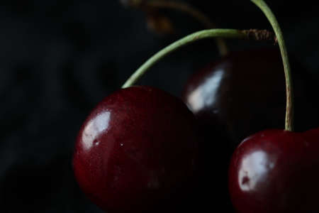 Fresh sweet ripe cherries on black background.の写真素材