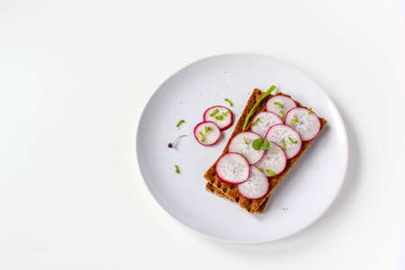 Bread rolls with chopped radishes and herbs. Sandwich with vegetables and basil.の写真素材