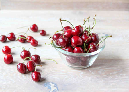 Fresh ripe red berries on a bowl on the rustic background