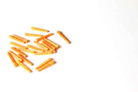 Plastic orange dowels on the white background. Construction and building background.の写真素材