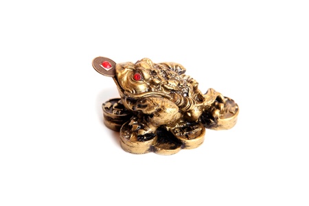 A bronze feng shui frog with a coin in its mouth, isolatedの写真素材
