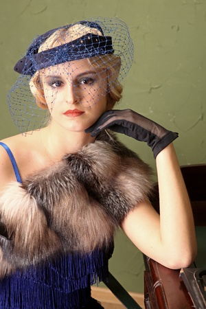 A portrait of a beautiful young girl dressed in the style of 1920's