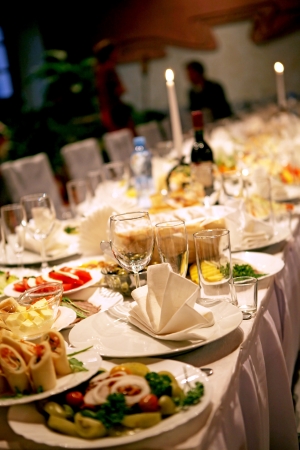A richly laid table of European cuisine, beautifully served with dishes, glasses and napkins の写真素材
