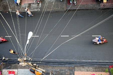 Power lines pulled above the road, top view. Saigon, Vietnam.のeditorial素材