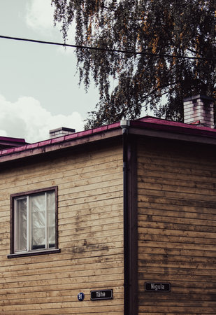 Old wooden house on the street. Photo in old color image style.の写真素材