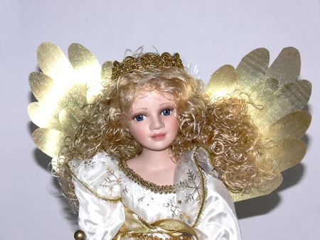 A portrait of an angel with gold wings and an porcelain face and blond hair.  50239	の写真素材