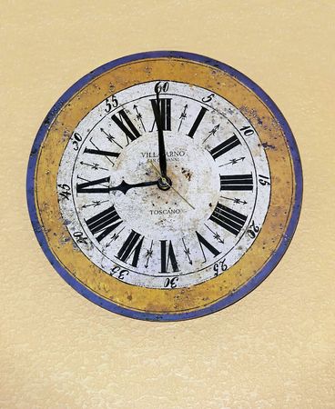 	An old antique kitchen clock with roman numbers on yellow background.  60012		の写真素材