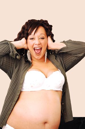 An beautiful pregnant woman screaming, in only bra and panties and jacket in her home.  の写真素材