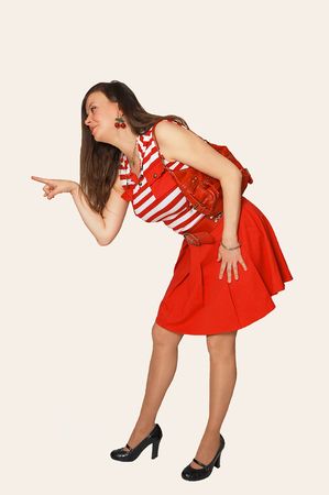 A young pretty woman standing in a short red skirt and purse, for white background and shooing her great figure. の写真素材