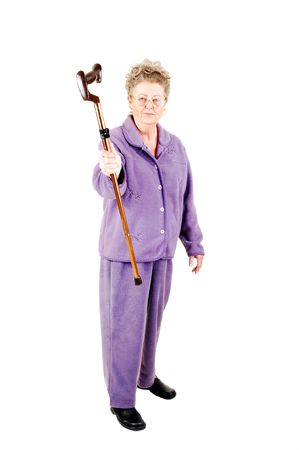 Senior woman with gray hair and an lilac suit needs the help of a cane to get around. On white background.の写真素材