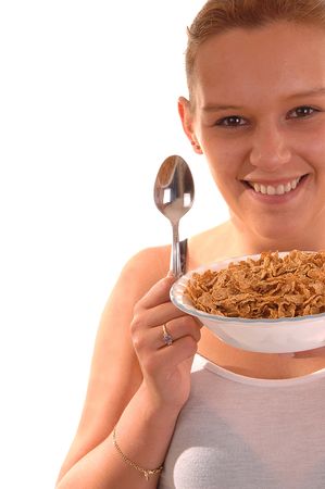 An lovely young woman holding a bowl of cereal and the spoon is ready to have her healthy breakfast.