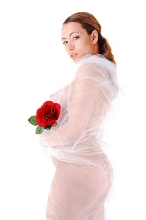Young pretty nude woman with white twill around her body and a red rose in her hand, for white background.の写真素材