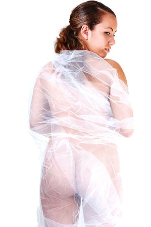 Young pretty woman, nude, with white twill around her body, standing with her back to the camera, for white background.の写真素材