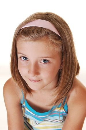 Closeup of a very pretty young girl with blond hair, looking into the the camera, on white background.の写真素材