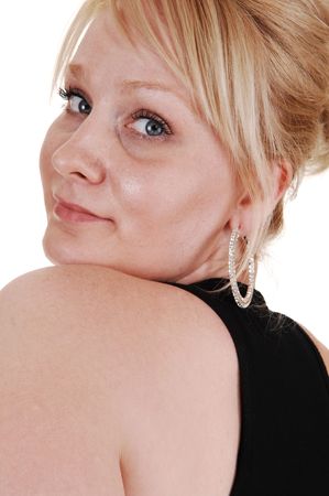 An head shoot of a blond pretty woman, looking over her shoulder in an black dress for white background. の写真素材